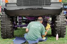 Charlie Herring of Bealeton, Va., wipes down the undercarriage of his 1990 Ford F-250 pickup while sitting on the Bloomsburg Fairgrounds Friday afternoon at the 4-Wheel Jamboree Nationals. This is the second time in the past five years Herring has made the 4.5 hour journey to participate in the event. 