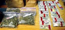 Plastic bags of marijuana buds and $47,000 in cash are displayed at the Locust Township police station on Tuesday that were seized at Richard A. Zambor’s Roaring Creek Township home on Monday.
