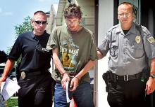 Steven Eugene Houser, 49, of Briar Creek Township, is escorted out of the Salem Township police station by Ptlm. Justin St. Clair, left, and Ptlm. Fred Westover on Monday afternoon. 