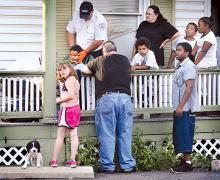 Danville Ambulance personnel tend to Renard Durant, 5, of Bloomsburg, on a West Street porch after he collided with a car driven by Phyllis Roberts, 76, of Catawissa, on West Street near West Third St., in Bloomsburg on Sunday evening. Police said the child complained of leg pain. 