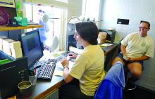 Ashley Stewart, left and Courtney Ehmer work the ticket sales counter at the Bloomsburg Fair Grandstand Saturday morning. 