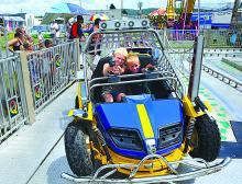 Siblings Jayda, 10, and Emerson Beagle, 5, ride on Quadzilla Sunday at the Lycoming County Fair in Hughesville. The fair continues through Saturday with rides, food, exhibits and entertainment nightly.