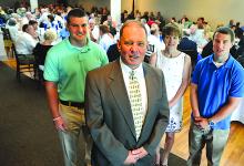 Former Bloomsburg Police Chief Leo Sokoloski, front, poses with his wife, Kathy, and son, Chris, Sunday during a surprise party in his honor at Rolling Pines Golf Course in South Centre Township.