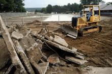 Carl Rinehimer with Carl E. Rinehimer Excavating and Hauling of Berwick, bulldozes up the concrete decking around the Ber-Vaughn Pool Wednesday afternoon while work gets underway on the upgrades at the facility. The pool will be extended to cover the area where the bulldozer is working to and a walk in shallow end.