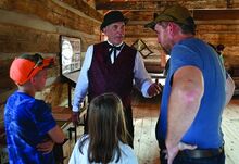 John Marr in character as Amandus Heddens talks about the history of Washingtonville while standing in a historic cabin on display at the Montour DeLong Fair this week. 