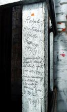 The death of Ralph Hartman in 1943 and a commissioner’s disagreement in 1944 are noted on this piece of wood in the courthouse clock tower. 