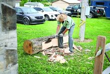 Van Wagner, an agriculture teacher at Danville High School, demonstrates log hewing at the Montour-Delong Community Fair on Tuesday in Washingtonville.