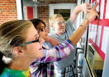 Berwick Middle School soon-to-be-eighth-graders, from left, Autumn Kinney, Elizabeth Diltz and Matthew Gilbert check the homeroom assignments for the coming school year posted on the doors to the middle school on Tuesday. Wednesday, Aug. 21, is the first day of school for students in the Berwick Area School District. 