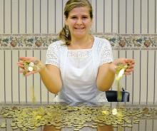 Bloomsburg Downtown Manager Adrienne Mael displays a collection of the new parking tokens which businesses can purchases and give to their costumers for free to use in the meters for parking. Each token is worth 24 minutes and goes in the quarter slot in the meter. 