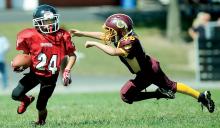 Berwick Redskins' Donald Rinehimer dives to make a tackle on Bloomsburg running back Damon Rasmussen after Rasmussen cut back on the defense near the sideline during the third quarter Sunday at Bloomsburg. Rasmussen ran for a Bloomsburg touchdown.