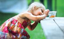 Gabriella Lindenmuth, 3, Catawissa, tries to get an up-close look at a goldfish she won with the help of her father Wednesday on the opening night of the Catawissa Firefighters' annual Carnival. The carnival runs through Saturday night, with entertainment each night at 7 p.m.