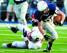 Berwick's Kyle Trenholm, front, runs past a tackle by Crestwood's Frank Algeldinger during Friday's season opener in Berwick.