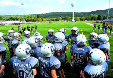 The Central Youth Football League B Team huddles on the new turf field at Central Columbia before taking the field for the first time this season to play the Catawissa Redskins Wednesday evening. The Central league is made up of the former Orangeville Cornhuskers and Miff-Ridge Bandit teams.