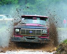 Allen Yoder makes a complete run in his 1986 Ford pickup Sunday at the Bloomsburg Fairgrounds during the Boondockers 4x4 Club's mud bog to benefit local charities.