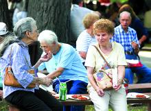 Irene Sivilich, left, and Lorraine Carpenetti talk over potato pancakes at the St. Mary's Church Holy Spirit Parish Homecoming festival Saturday evening in Mocanaqua. The festival continues today from 12:30 p.m. until 9:30 p.m.