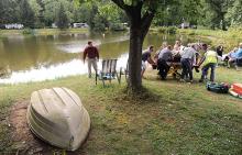 Rescue personnel move Virginia Lindenmuth to a nearby ambulance after she was rescued from a car submerged in the pond at Ideal Park in Locust Township Thursday afternoon.