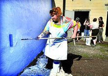 ress Enterprise/Bill Hughes Katrina Roman rolls on blue background paint for the River Oyster Project, a mural on the Berwick side of the Berwick-Nescopeck bridge over the Susquehanna River, on Saturday afternoon. Behind her are fellow artists, from left, Courtney McCabe, Stephanie Roman, Maria Roman and Tara Mangan.