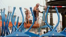 Kenny Hebert ratchets in a bolt to mount the 52nd car on the line while setting up the sky ride Wednesday afternoon on the Bloomsburg Fairgrounds. 