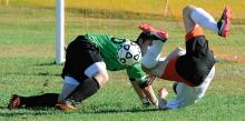 Benton's Grant Lyons, right, rolls to the ground after colliding with Millville's goalkeeper Britton Kittle during the first half of Tuesday afternoon's game at Benton. 