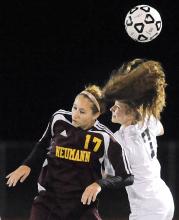 Saint John Neumann's Meghan Trenholm, left, heads the ball over Central Columbia's Emma Padner during first half play in Wednesday night's game at Central. 