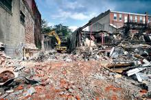 A Sokol Inc. crew continues demolition of the old JC Penney building in downtown Bloomsburg on Friday. The Bloomsburg University Foundation will construct a $6.5 million, four-story office building on the site. 