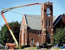 A crew from Donald E. Kocher Masonry Contractor, Orangeville, makes repairs to the top of the bell tower on the First Reformed United Church of Christ in Berwick on Tuesday. Church secretary Linda Freas said the repairs were made necessary by a lightning strike to the bell tower during the summer of 2011. 