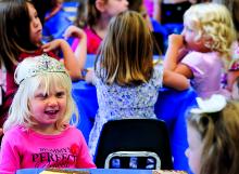 St. Cyril Academy preschool student Greta Facktor, smiles as she wears a crown during the preschool's Mother-Daughter Tea, held Sunday in the St. Cyril Villa in Danville. There were also father-son hikes held. 