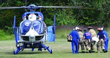 Bonnie Vought is carried to a Geisinger Life Flight helicopter at the Salem Fire Company carnival grounds Monday afternoon before being flown to the hospital for treatment. 