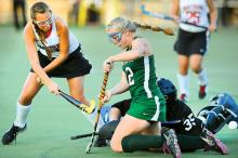 Bloomsburg's Alex Luxardo knocks a shot into the goal as Lewisburg's Cassie Sumfest and goalie Dentin Kline try to stop it late in the first half of their game at Bucknell Monday.