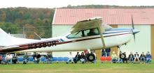 A Cessna Skylark takes off as spectators watch at the 5th Annual Fly-in at the Benton Airport Saturday. More than 80 aircraft from vintage to modern -- along with experimental -- were available to be viewed by the hundreds of spectators.