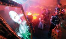 Cassie Kendron, 3, left, and Jack Kendron, 6, walk past a talking picture after picking up a treat from one of the tables at the Berwick YMCA's Trick-or-Treat Trail Monday evening which winded through the building in Berwick. Each of the tables the kids stopped at had a treat and a safety tip for them. 