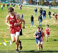 Mount Carmel’s Tommy Moser climbs a small hill on the Bloomsburg University cross country course during the District 4 Boys AA meet on Thursday.