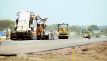 Asphalt is placed on the recently realigned runway at the Bloomsburg Airport Monday morning. The new runway will be 3,200 feet, 400 feet longer than the old runway, with new lighting. The work is being done by Dobrinski Brothers of Tunkhannock.