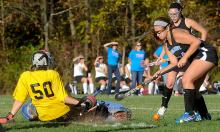 Southern Columbia's goalkeeper, Molly Van Wieren, left, slides while trying to block a ball hit by Midd-West's Alexxa Dauberman during the first half of Monday afternoon's game at Southern. 