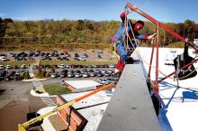 Dressed as Spiderman, window washer Josh Williams, with Performance Services of Harrisburg, climbs over the parapet from the roof while working at Geisinger-Bloomsburg Hospital on Tuesday afternoon. 