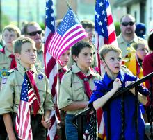 Area Boy Scouts, from left, David Pace, Zachary Cohan and Noah Conrad listen during a short ceremony before the Columbus Day Parade in Berwick Sunday.