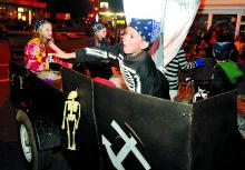 Landon Rogers, 7, throws candy from the Family Care and Home Health Agency float Saturday in the Catawissa Halloween Parade.