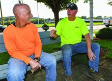 Brian Witmer, left, and Dan Gable sit on a bench in Zamboni Park Thursday after work while talking about how long they have been friends. Gable will donate 40% of his liver to Witmer. 