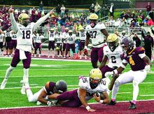 Press Enterprise/Bill Hughes Kutztown University’s Jaedyn Stewart falls into the end zone for a touchdown as he is tackled by Bloomsburg University defender Quentin Gaskill on Danny Hale Field at Redman Stadium on Saturday. Celebrating, at left, is Kutztown’s Judd Novak. At right is Bloomsburg’s Davin Fleming. Kutztown won 24-3.