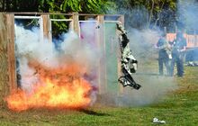 Two police officers trigger their charges on door to remove the doors from the hinges Tuesday while taking the Explosive Handlers and Breaching class at the Catawissa range. A piece of old fire hose used in creating the charge flies through the air away from the door it was on after detonation. When complete the police officers will be certified for three years. This is the second year the class has been held locally. 