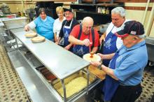 Members of the Caldwell Consistory in Bloomsburg, from left: Debbie Miller, Judy Weaver, John Schickram, Karl Schaefer, Don Weaver and Lynn Sheehan prepare to plate up the spaghetti at the Second Annual Election Day Spaghetti Dinner Tuesday morning at the Consistory on Market Street. 