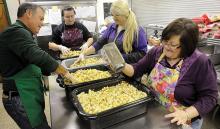 From left, Dave Brady, Katie Snyder, Jenny Newcomb and Karen Bialecki mix the stuffing for the Danville Community Thanksgiving Dinner, which will be Thursday at noon at St. Joseph School on Ferry Street. 