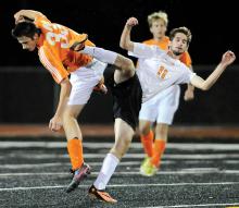 Danville's Tyler Deal, left, and Tunkhannock's Aidan Cronin fall to the turf after Deal heads the ball away as Cronin gets called with the push during the first half of Tuesday night's state playoff game at Lake Lehman. 