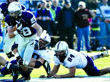 Berwick's Kyle Trenholm, left, runs against defenders Joe Deitz and Chase Wickenheiser Saturday at Crispin Field.