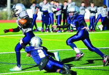 Central B team Silver player Ben Montgomery, left, runs past a tackle by Blue team's Dylan Harris during the Central Youth Football League B team Super Bowl, held Sunday at Central Columbia.