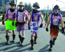 Berwick firefighters Matt Richards, Bill Coolbaugh, Jason Holloway and Steve Powers are shown during the Speedo Run Saturday on Market Street in Berwick.