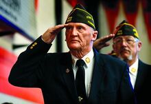 United States Army Vietnam War veteran and Benton VFW member Eugene Turner salutes the flag during the playing of the National Anthem at the annual Benton Area School District Veterans Day program Wednesday. 