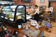 Natalia Bundziak, owner of the new Little Bakery along Center Street in Bloomsburg, creates a Chimney Cake Tuesday afternoon. 