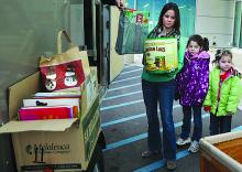 Becky Purcell, left, and daughters Aubrey, 8, and Kaeley Pequignot, of Covington, deliver toys for patients of Geisinger's Janet Weis Children's Hospital on Wednesday afternoon near Danville.