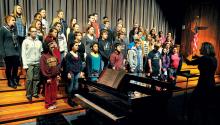 Music teacher Tara Smargiassi, right, leads the Central Columbia High School chorus in rehearsal in the school auditorium on Thursday morning. The chorus and the band, directed by Kevin Haile, will perform in the school’s annual Holiday Concert tonight in the high school auditorium. Doors open at 6:35 p.m. and the concert begins at 7.
